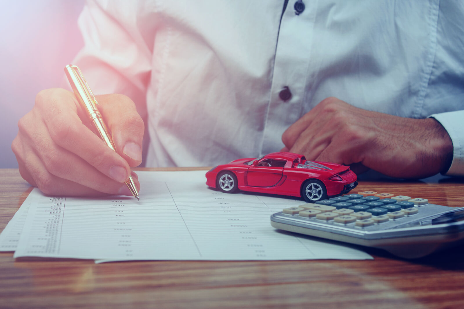 Car keys and loan documents on a desk